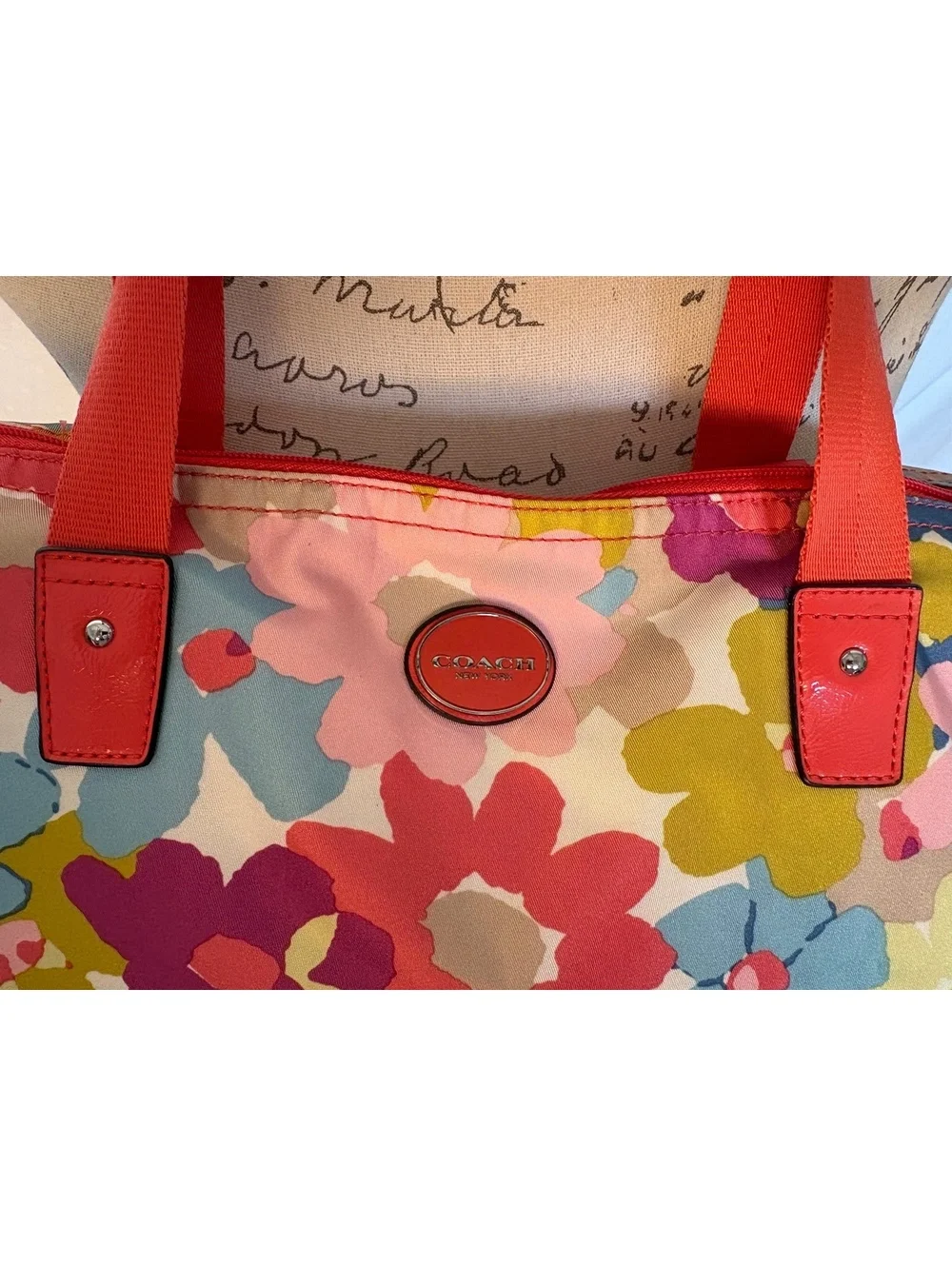 Bright and cheerful Coach tote featuring an oversized multicolor floral print.